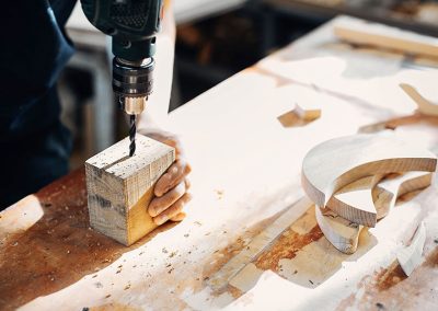 DMT Carpentry drilling holes in wooden block